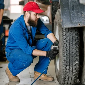 A mechanic performing ruck tire repair to prevent costly damage.