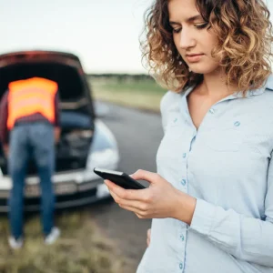 A woman calling a calling a roadside assistance.